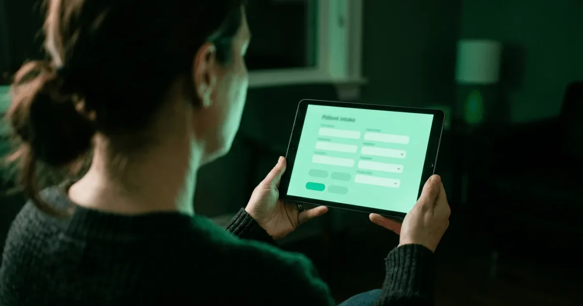 Patient completing a digital intake form on a tablet